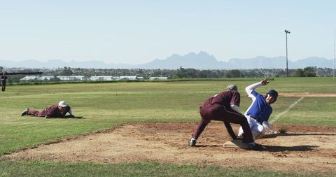 Baseball Player Diving to Base During Exciting Game