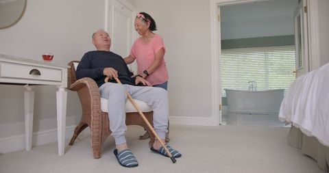 Asian Senior Couple Relaxing at Home with Support and Care