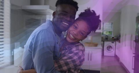Loving couple embracing in modern kitchen highlighting intimacy