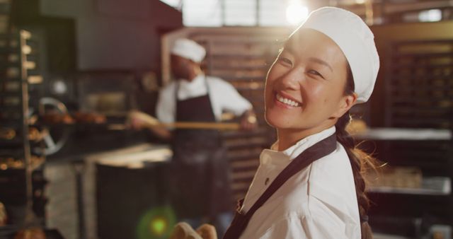 Image of happy asian female baker holding basket with baguettes - Download Free Stock Photos Pikwizard.com