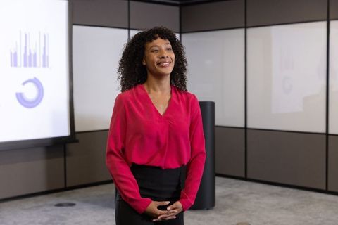 Professional presenter giving business presentation in modern boardroom