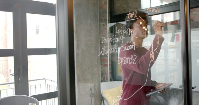 Young Professional Brainstorming Ideas on Glass Wall in Modern Office - Download Free Stock Images Pikwizard.com