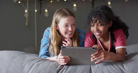 Smiling Teenage Friends Enjoying Time with Tablet - Download Free Stock Images Pikwizard.com