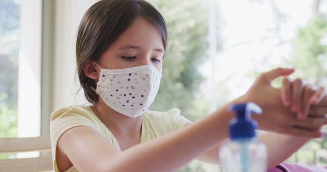 Young Girl Wearing Face Mask Using Hand Sanitizer at Home - Download Free Stock Images Pikwizard.com