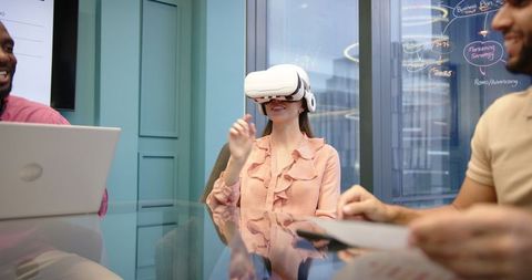 Businesswoman Using VR Headset in Modern Office Meeting