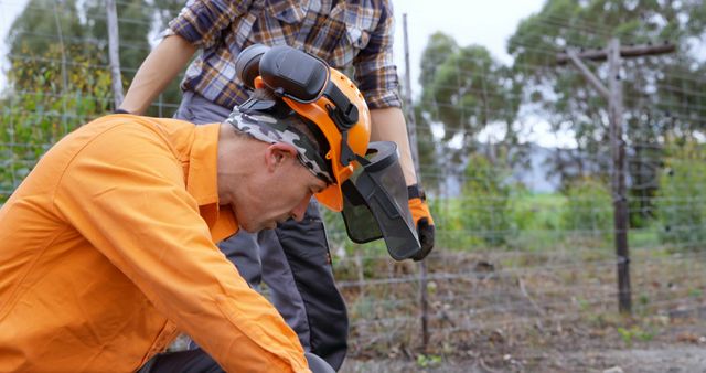 Focused Man Working in Garden with Protective Gear - Download Free Stock Images Pikwizard.com