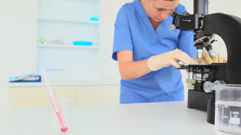 Scientist Conducting Experiment with Microscope in Modern Laboratory