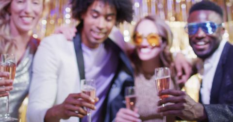 Friends Celebrating at Nightclub Toasting Champagne