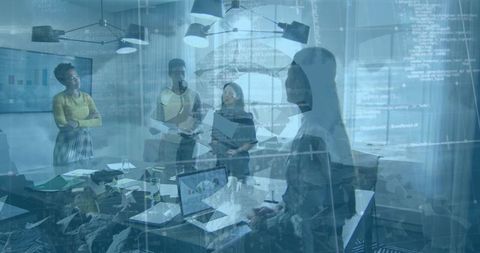 Diverse team collaborating and analyzing data on laptops in modern office conference room