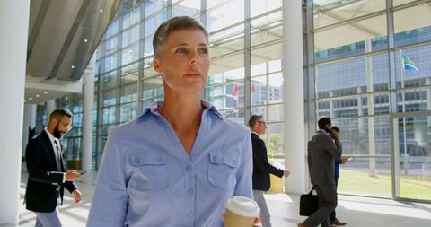 Focused Businesswoman Walking Through Modern Office Lobby - Download Free Stock Images Pikwizard.com