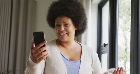 Happy African American Woman Enjoying Smartphone at Home - Download Free Stock Images Pikwizard.com