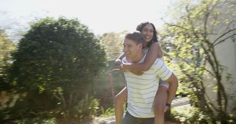 Joyful Couple Bonding in Sunny Backyard Garden