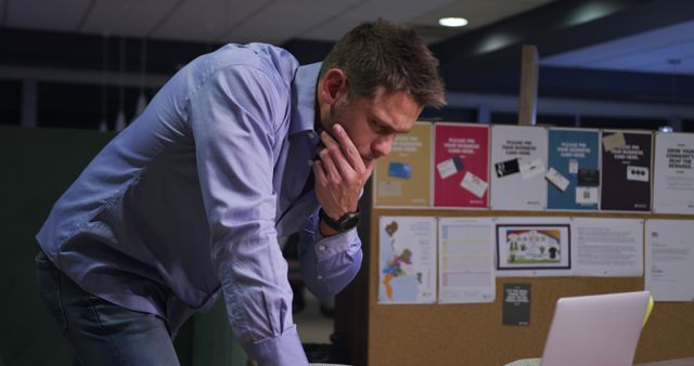 Man Working Late at Office Standing near Laptop - Download Free Stock Images Pikwizard.com