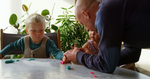 Father Engages Young Children in Creative Clay Play at Home