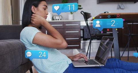 Young Woman Engaging with Social Media Notifications on Laptop