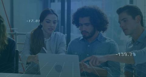 Colleagues analyzing data together in modern office setting