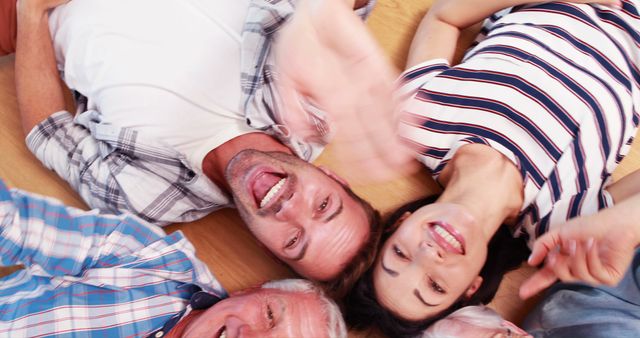 Joyful Family Lying on Floor Laughing Together - Download Free Stock Images Pikwizard.com