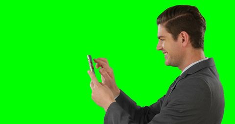 Young Businessman Engaged with Smartphone and Green Background - Download Free Stock Images Pikwizard.com