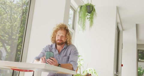 Caucasian Man Relaxing in Cafe Using Smartphone - Download Free Stock Images Pikwizard.com