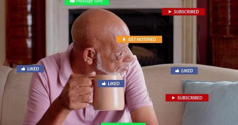 Sipping senior man on sofa holding coffee mug with social media liked and subscribed badges