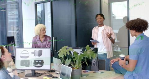 Diverse team brainstorming while presenter showcasing vr headset prototype in modern office