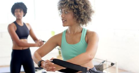 Women Practicing Yoga in Bright Studio Emphasizing Focus and Movement Balance