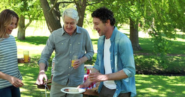 Multi-generational Family Gathering Outdoors with Food and Drinks - Download Free Stock Images Pikwizard.com