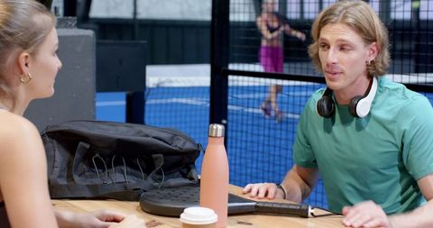 Training Partners Resting Near Padel Court With Gear and Drinks