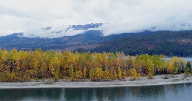 Autumn forest and mountain ranges along the lake during winter 4k