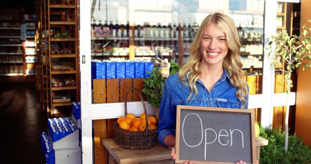 Smiling Store Owner Holding Open Sign in Front of Shop - Download Free Stock Images Pikwizard.com