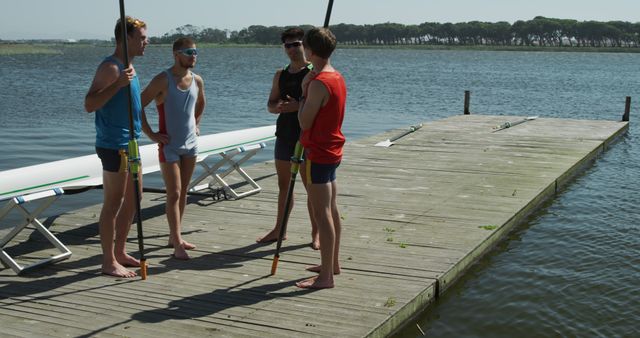 Team of Young Rowers Discussing Strategy on Lake Dock - Download Free Stock Images Pikwizard.com