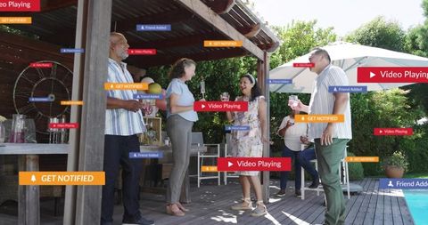 Group socializing poolside on backyard deck with social media notification overlays