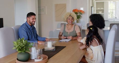 Diverse family laughing and bonding at dining table