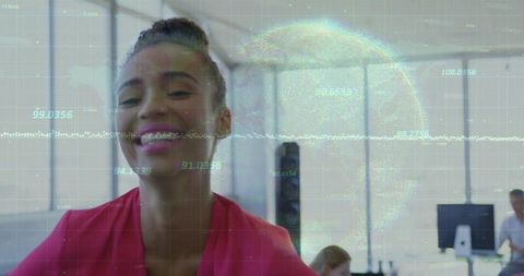 Smiling professional leaning toward camera in bright open office with digital data overlay