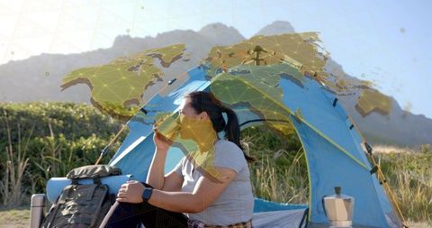 Camper enjoying nature at campsite with tent and backpack
