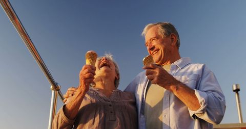 Joyful Senior Couple Enjoying Ice Cream at Waterfront - Download Free Stock Images Pikwizard.com