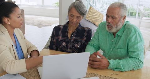 Senior Couple Consulting Financial Advisor at Home