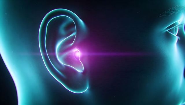 Futuristic ear implant emitting neon cyan and magenta glow representing hearing tech