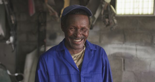 Mechanic Laughing in Workshop Wearing Blue Uniform and Cap - Download Free Stock Images Pikwizard.com