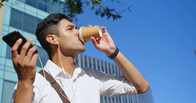 Young Urban Professional Drinking Coffee and Listening to Music - Download Free Stock Images Pikwizard.com