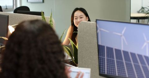 Diverse Coworkers Planning Renewable Energy Solutions in Office