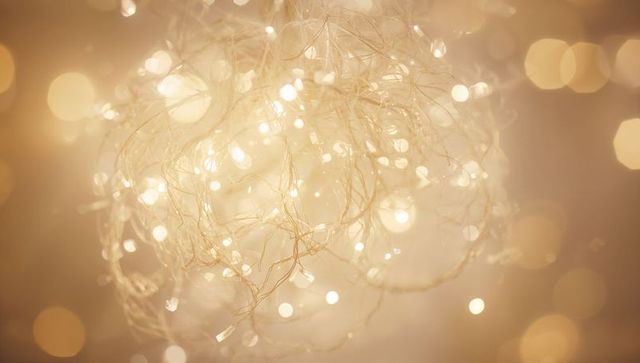 Glowing golden orb of fairy lights creating soft bokeh and warm festive atmosphere