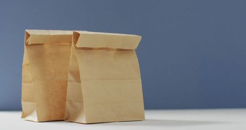 minimalist paper lunch bags against blue background - Download Free Stock Images Pikwizard.com