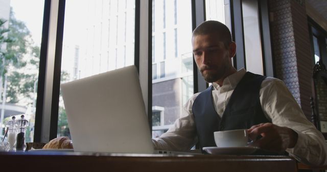 Businessman Working on Laptop in Modern Cafe - Download Free Stock Images Pikwizard.com