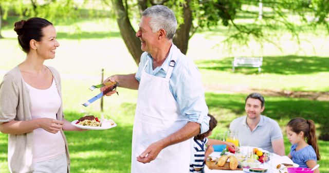 Family Enjoying Barbecue Picnic in Park on Sunny Day - Download Free Stock Images Pikwizard.com