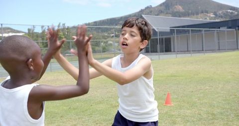 Children Playing Pat-a-Cake Game Outdoors on Field