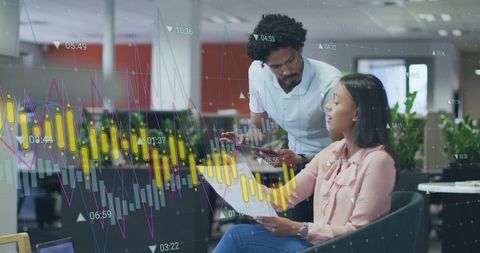 Colleagues Analyzing Data Charts in Modern Office Environment