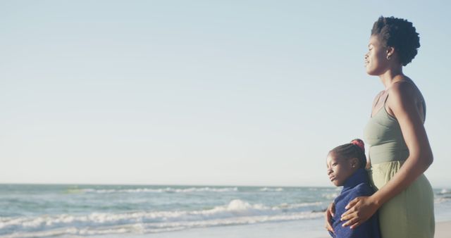 Mother and Daughter Embracing by the Sea at Sunset - Download Free Stock Images Pikwizard.com