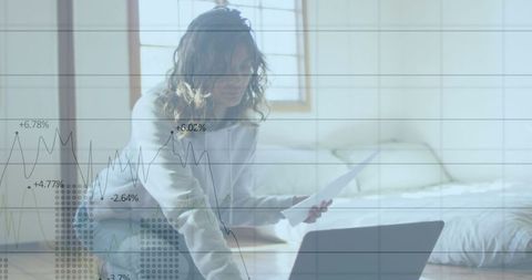 Financial stats overlay with woman managing bills online