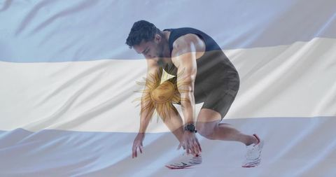 Sprinter preparing for race with argentina flag overlay, powerful start pose and focus